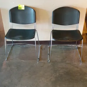 Metal frame side chair. Features a contoured black poly seat and back mounted on a chrome-finished metal sled base. 19"W x 16"D x 33"H.