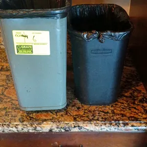 Lot of (2) poly trash cans. Includes (1) Rubbermaid Commercial Products black poly trash can and (1) gray rectangular poly trash can.