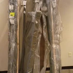 Quantity of assorted bed rails. Includes both wood-look and metal rails, mostly wrapped in protective plastic packaging. Features various styles and s