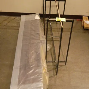 Quantity of assorted bed rails. Lot includes a plastic-wrapped bundle of finished wooden bed rails and three welded metal support frames.