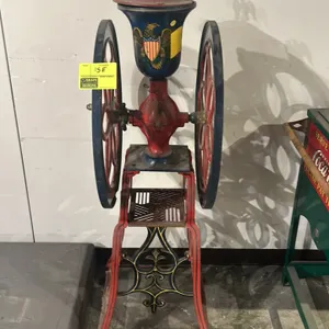 A Vintage Enterprise Mfg. Co. Floor Model Coffee Grinder. (Enterprise Mfg. Co., late 19th century) A double-wheel cast iron floor model coffee grinder