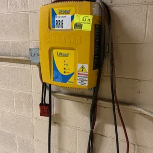 Hawker LIFEtech LT3-12-140Y high-frequency smart battery charger. Features a wall-mounted design, charging cable with red connector, and 8-hour charge