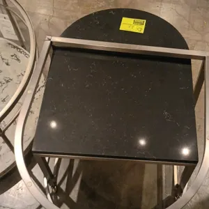 2-piece nesting end table set. Features black veined stone-look tops and brushed metal frames. Designed to nest together for versatile layout options.