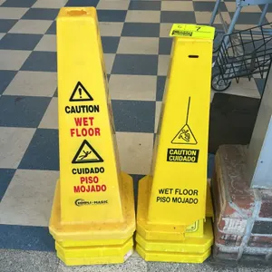 Simpli-Magic and other poly wet floor cones. Features high-visibility yellow plastic construction with bilingual English and Spanish safety warnings o