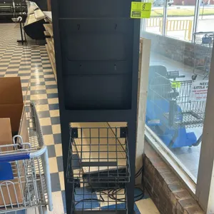 Metal sign stand with merchandising baskets. Features black metal construction with a top sign holder slot and two tiered wire baskets below. Mounted 