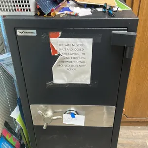 AMSEC metal office safe. Features a manual combination lock and a 3-spoke turn handle. Dark gray finish. 25"x29"x53". Combination is included (163806)
