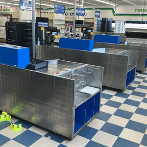 AFCO stainless steel checkout lane. Features a stainless steel deck, integrated bagging area with dual wire bag racks, blue laminate open shelving, an