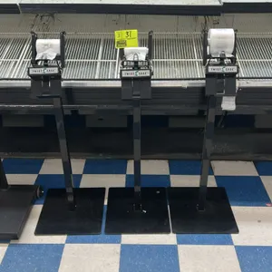 Twist-Ease metal produce bag stand. Features a black metal post and flat weighted base. Equipped with a Twist-Ease bag dispenser on top. Display case 