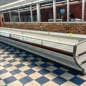 1992 Tyler DMRG12 36'L open island meat display case lineup. Features three 12'L sections, open top design, and white wire shelving. Electrical: 115V/