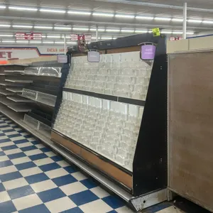 Gondola shelving. Features double-sided metal shelves, woodgrain backing panels, and price tag channels. Includes integrated card display section. Dim