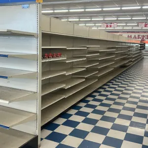 164'L of Lozier double-sided gondola shelving. Features cream-colored metal construction with solid back panels and adjustable shelves. Measures 84"H 