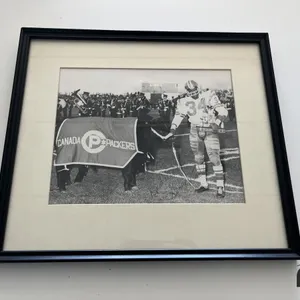 Photo of George w/ a Cow Receiving Canada Packers Players of the Year Award 
 UNRESERVED