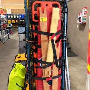 BLACK METAL 82" SAFETY MAN BASKET WITH ORANGE PLASTIC SPINE BOARD, RED CUSHION, WOODEN SPLINTS &