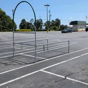 Galvanized metal shopping cart corral. Features a tubular metal frame construction with a green painted overhead decorative arch. 115"x72"x105".