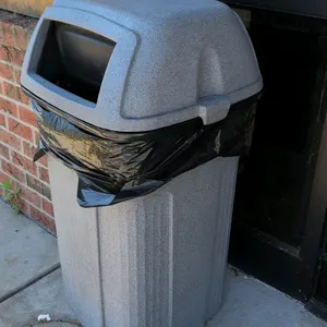 Poly waste bin. Features a dome lid with a self-closing swing door. Durable plastic construction with a gray speckled stone finish. 44"H. Free-standin