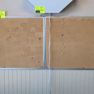 Metal framed corkboard. Features a natural cork tack surface and a silver-tone aluminum frame. Wall mountable design. Dimensions: 3' x 2'.