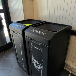 Poly waste bins. Set of (2) black molded plastic recycling bins, one labeled 'PLASTIC' and one labeled 'PAPER'. Features removable lids with dedicated
