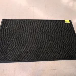 Unbranded commercial entrance rug. Features a charcoal gray ribbed fiber surface with a basketweave pattern and a black rubber border. 33"W x 59"L. Ba
