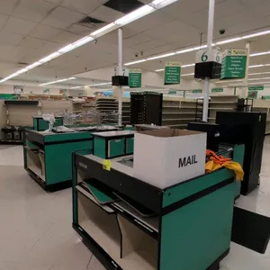 Reynolds Corporation UL-1 Series single belt checkout lane. Features green laminate panels, integrated conveyor belt, and bagging area. Dimensions: 96