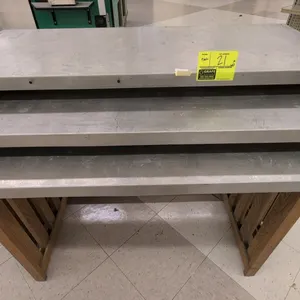 3-piece nesting table set. Features metal tops and wood slat bases. Includes three nesting tables ranging in size from 35" to 48"L.