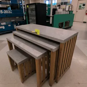 Nesting table set. Includes 4 tables of graduated sizes. Features metal tops with wood bases. Designed to nest together for compact storage or display
