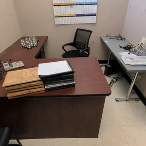 Office suite package. Includes a 60"x78" wood-grain laminate L-shaped desk, 60" gray laminate table with metal T-legs, 15" metal 4-drawer vertical fil