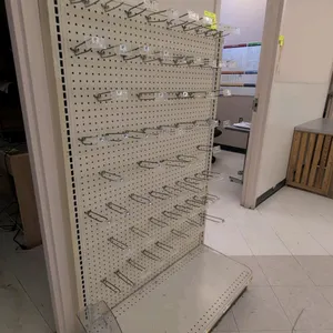 4'L of Madix wall shelving. Features an off-white finish, pegboard backing, peg hooks, and a 16"D base shelf. Measuring 4'L x 16"D x 60"H.