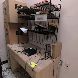 Wood desk with IT contents. Includes 48"L wooden desk, black wire-rack desktop hutch, JS-I3 4005u II LAN mini PC, power strip, two HP boxes, and Imagi