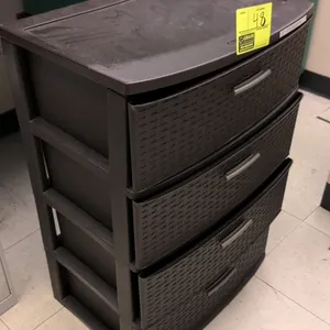Sterilite 4-drawer plastic storage tower. Features a brown weave-pattern design with four pull-out drawers and silver-tone handles. 22"W x 32"H.