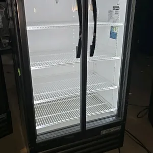 2020 True TVM-30-HC~VM01 2-door glass door merchandiser cooler. Features a black exterior with white aluminum interior, LED lighting, and adjustable w