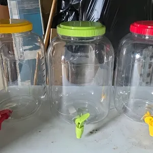 American Maid 2.9-gallon plastic Mason jar beverage dispenser. Features BPA-free plastic construction, a screw-top lid, and an integrated plastic disp