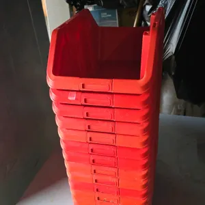 Zag plastic storage bin. Features red plastic construction with an open-front hopper design for easy access. Stackable and nestable. Dimensions: 9" x 