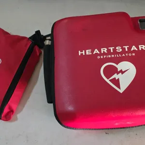 Philips HeartStart FR2+ defibrillator. Includes red semi-rigid carrying case, Fast Response Kit pouch, battery, quick reference guide, and sealed pads