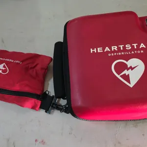 Philips HeartStart FR2+ automated external defibrillator (AED). Includes red carrying case, attached Fast Response Kit pouch, infant/child reduced ene
