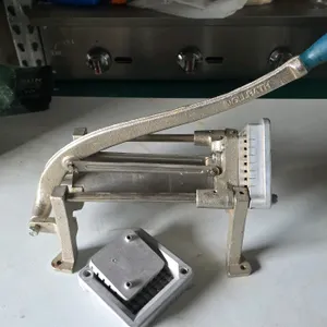 Vollrath manual french fry cutter. Features cast metal construction with a blue grip handle. Includes an extra cutting grid and pusher block assembly.