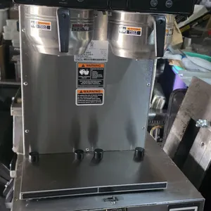 Bunn Axiom Twin APS digital commercial coffee brewer. Features stainless steel construction, dual brew heads with stainless steel brew baskets, digita