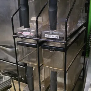 Bunn 4-position multi-hopper storage rack. Includes four removable plastic coffee bean hoppers with handles and lids. Features a black wire frame stan