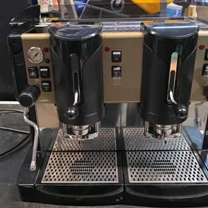 2016 Spinel Jessica 2 Pod espresso machine. Features 2-group pod system, built-in pressure gauge, dual wands, and black and gold-tone housing. Include