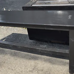 Custom wood bar table. Features a black painted finish and two integrated tabletop power strips, each containing two standard electrical outlets and t