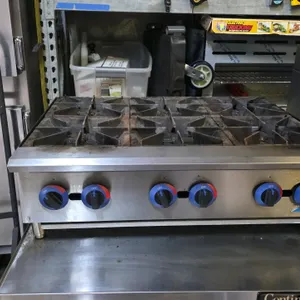 Comstock-Castle HP36-CC 36"W 6-burner gas countertop hot plate. Features cast iron grates, stainless steel construction, and individual manual control