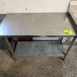 Stainless steel work table. Features a stainless steel top, adjustable galvanized steel undershelf, and galvanized steel legs with adjustable bullet f