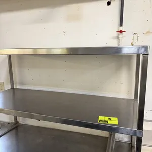 Stainless steel two-tier table overshelf. Features all-stainless steel construction with two shelving surfaces. Designed to mount onto a work table or