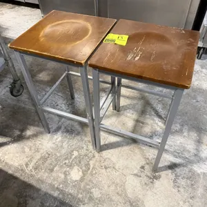 BFM Seating bar stool. Features a square contoured wooden seat and a gray metal frame with integrated footrests. 29"H. This item located at 912 Old Co