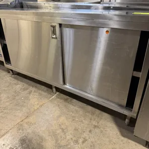 Stainless steel storage cabinet. Features two sliding doors, a middle shelf, and stainless steel construction. Dimensions: 72"W x 15"D x 36"H. Mounted