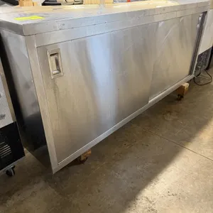 Stainless steel storage cabinet. Features a two-door design with sliding doors, recessed pull handles, and an interior divider partition. 72"W x 15"D 
