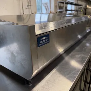 Arctic Air ACP55 refrigerated countertop condiment prep station. Features stainless steel construction, a hinged lid, and interior pan support rails. 