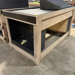 JSI Store Fixtures wooden produce and bakery display island. Features a natural wood frame, integrated black pegboard end compartments, and a textured