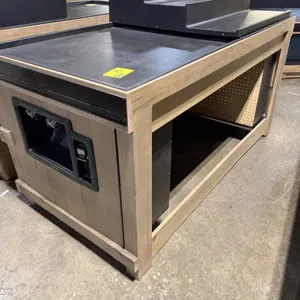 JSI Store Fixtures wooden display island. Features wood frame construction, a black textured top deck with a 3-step riser, a built-in Twist Ease bag d
