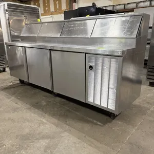 Delfield 18699PTBMP 3-door pizza refrigerated prep table. Features stainless steel construction, a top pan rail with hinged covers, and dual self-cont