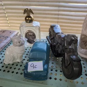 4 Avon bottles, motorcycle headlight is broken